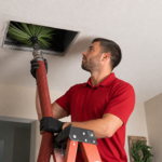 Professional duct cleaning process showing technician removing debris from ceiling vent